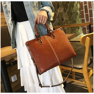 Black Leather Handbag | Elegant Tote | Brown Accents | Adjustable Strap | Spacious Design