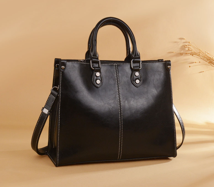 Black Leather Handbag | Elegant Tote | Brown Accents | Adjustable Strap | Spacious Design